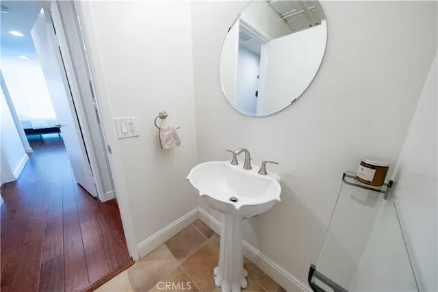 a bathroom with a sink a mirror and a shower
