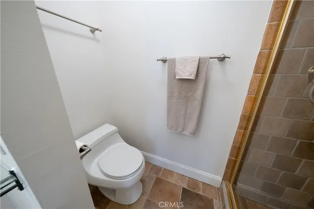 a white toilet sitting next to a small bathroom