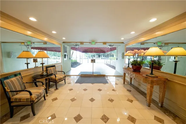 a lobby with a rug and a chair