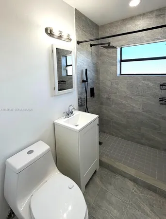a bathroom with a sink mirror and toilet
