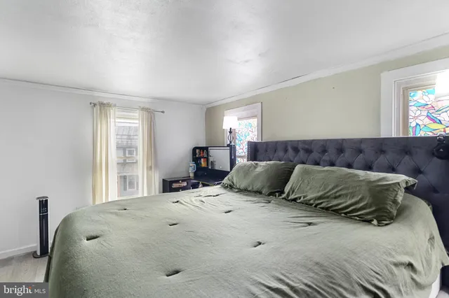 a bedroom with a large bed and a window