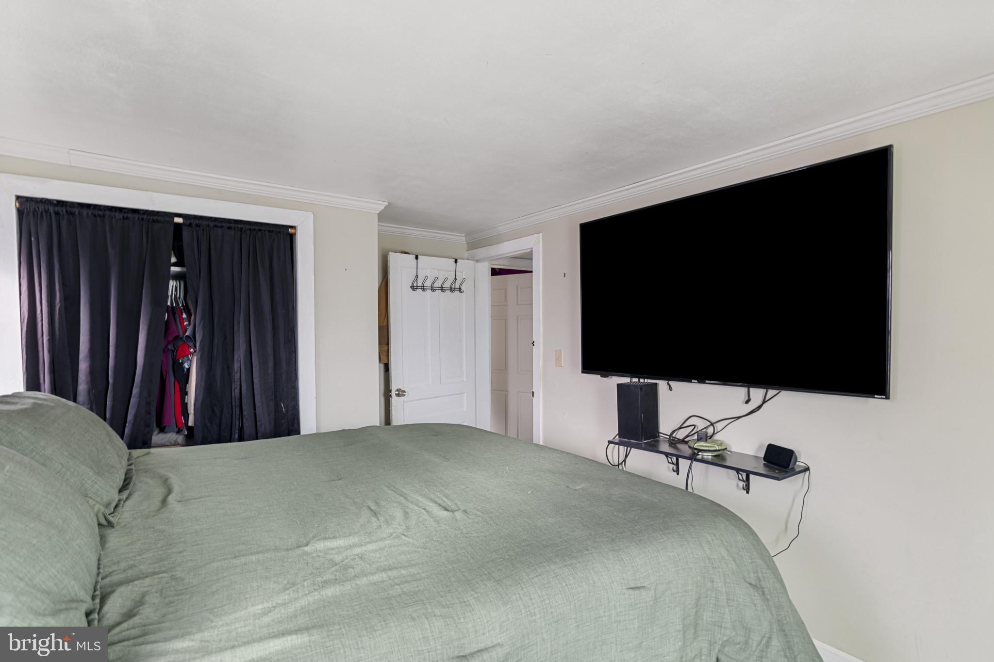 141 West King Street Littlestown, PA 17340 - Photo 18 of 31 a bedroom with a bed and a flat screen tv