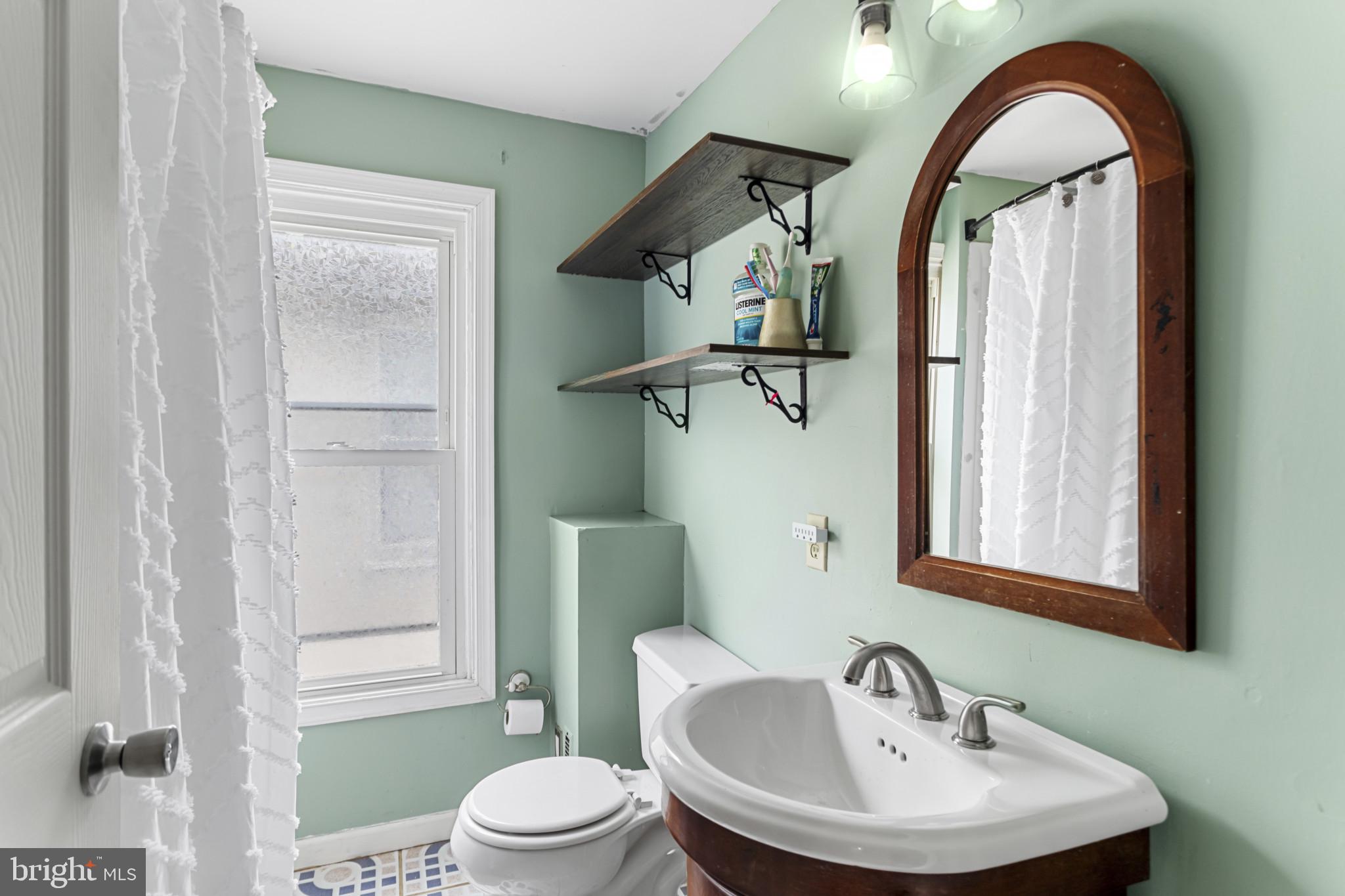 141 West King Street Littlestown, PA 17340 - Photo 19 of 31 a bathroom with a sink a toilet and a mirror