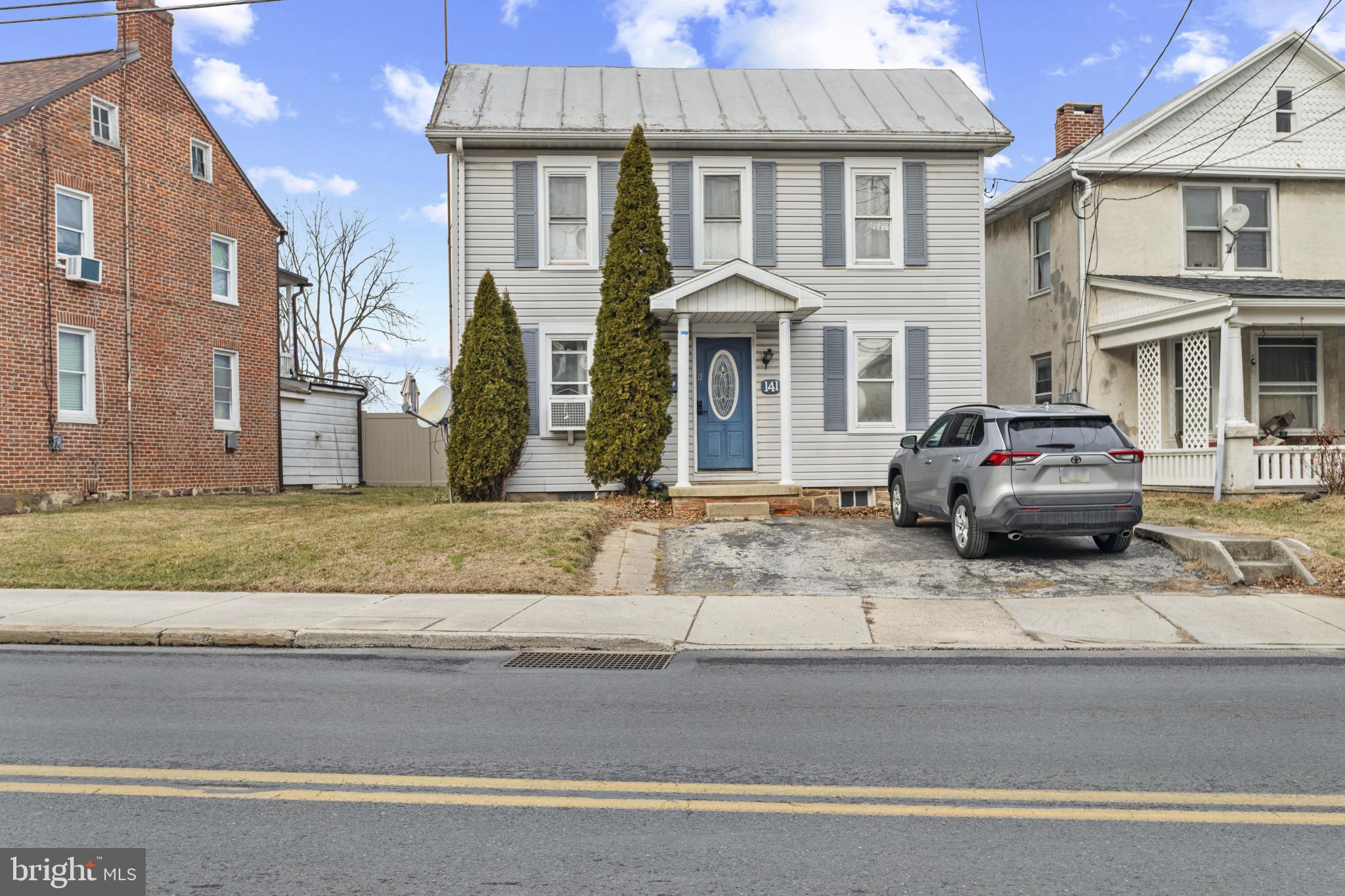 141 West King Street Littlestown, PA 17340 - Photo 2 of 31 a front view of a residential apartment building with garage and parking