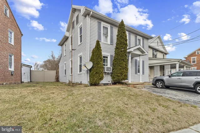 a view of a blue house with a large windows