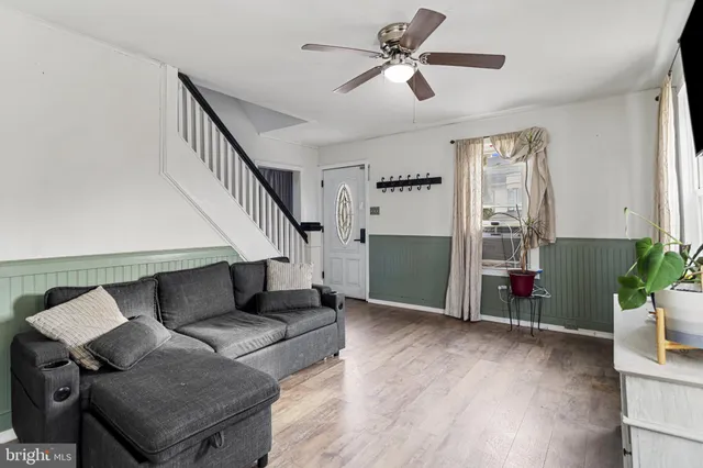 a living room with furniture and wooden floor