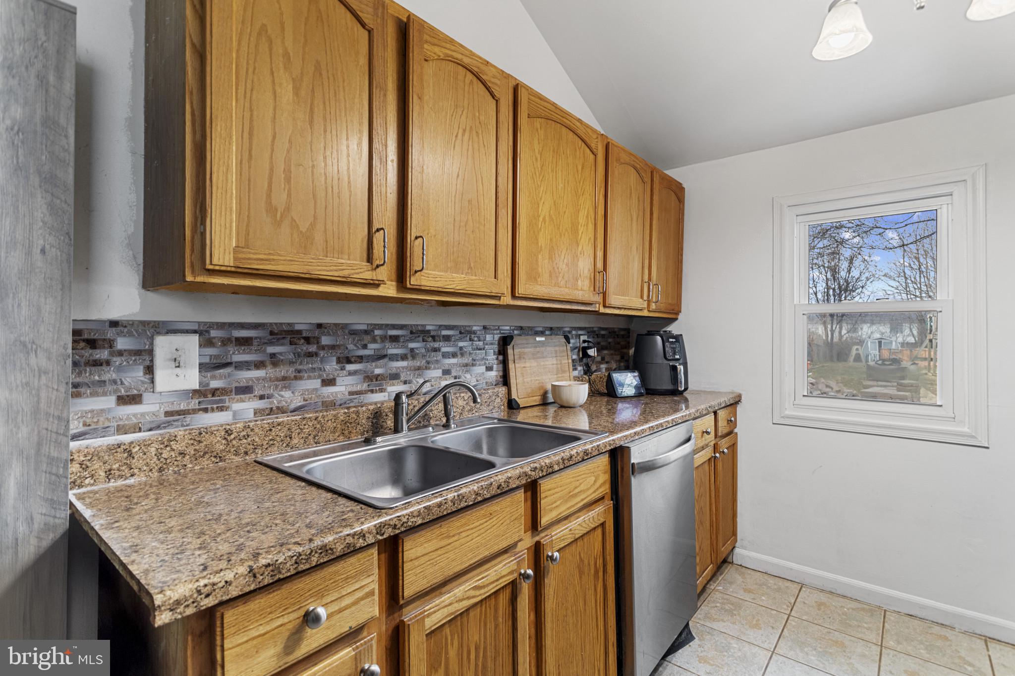 141 West King Street Littlestown, PA 17340 - Photo 8 of 31 a kitchen with stainless steel appliances granite countertop a sink stove and cabinets