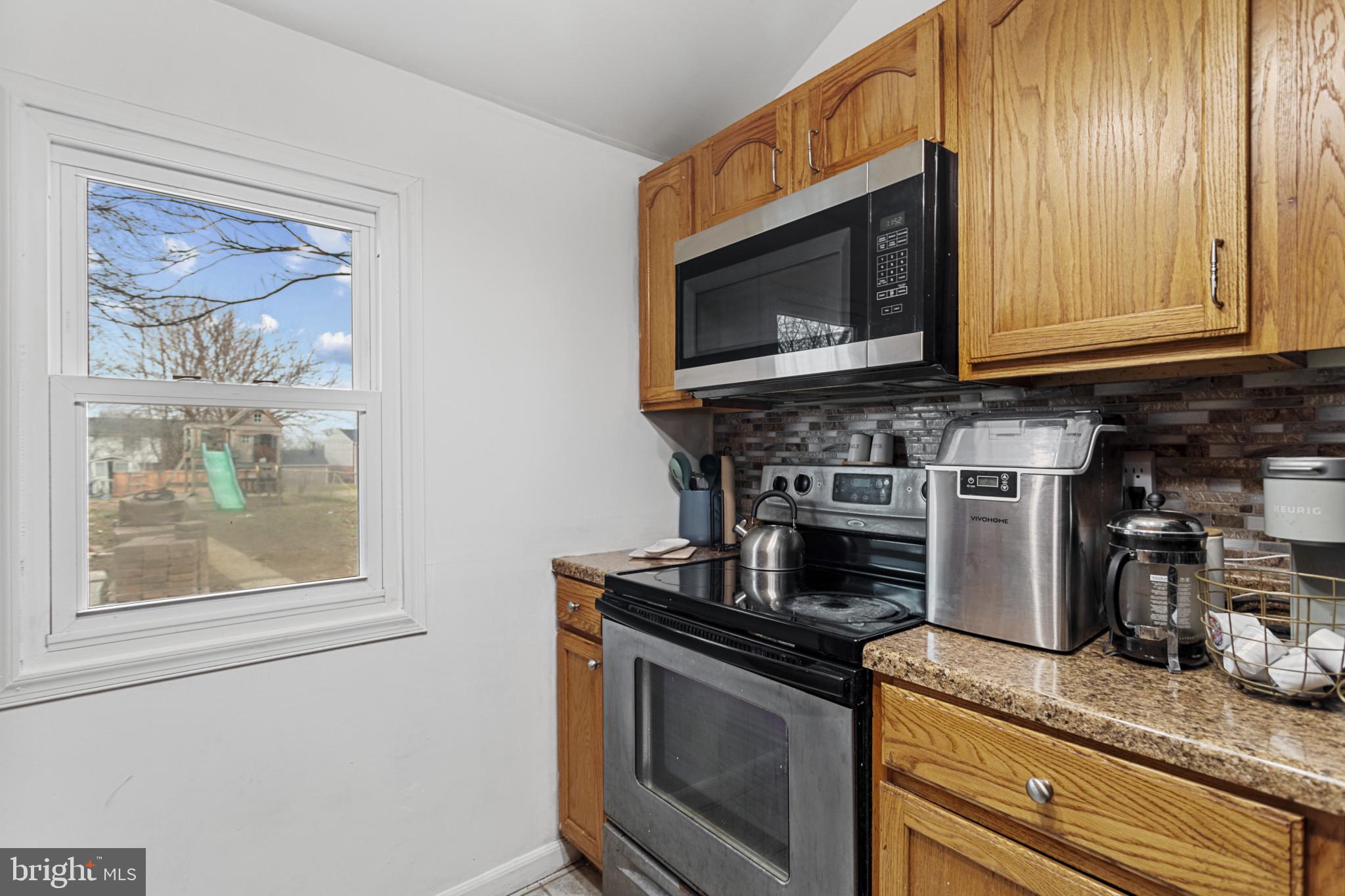 141 West King Street Littlestown, PA 17340 - Photo 10 of 31 a kitchen with stainless steel appliances granite countertop a stove microwave and cabinets