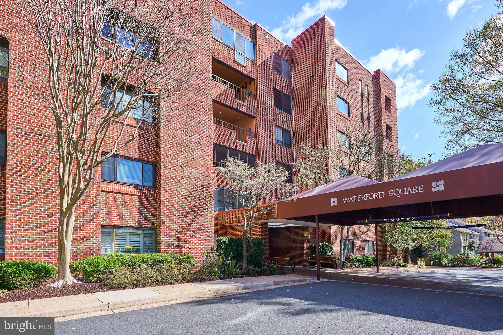11500 Fairway Drive, Unit 101 Reston, VA 20190 - Photo 1 of 40 a street view with tall buildings and a yard