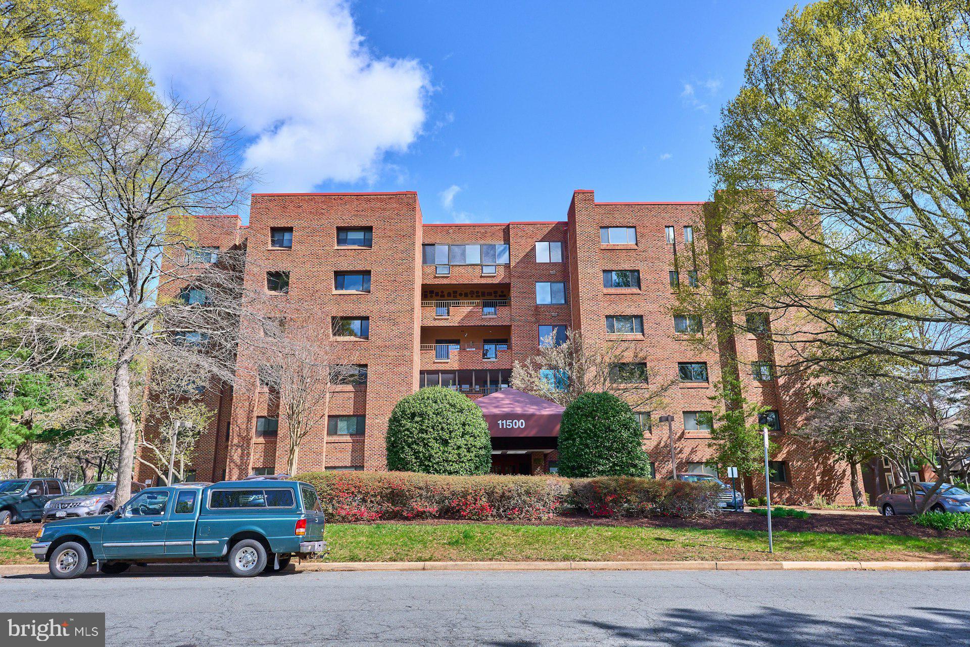 11500 Fairway Drive, Unit 101 Reston, VA 20190 - Photo 2 of 40 a car parked in front of a building with a yard