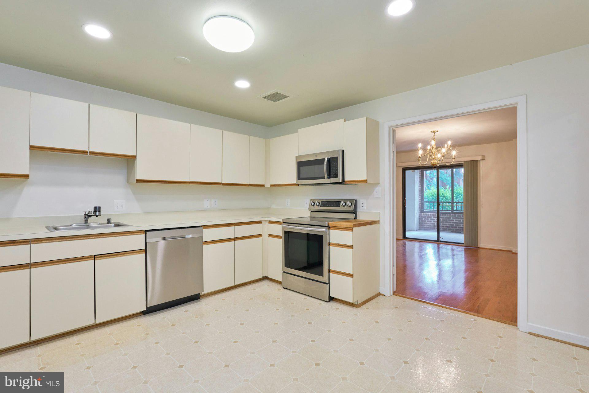 11500 Fairway Drive, Unit 101 Reston, VA 20190 - Photo 21 of 40 a kitchen with granite countertop white cabinets and white appliances