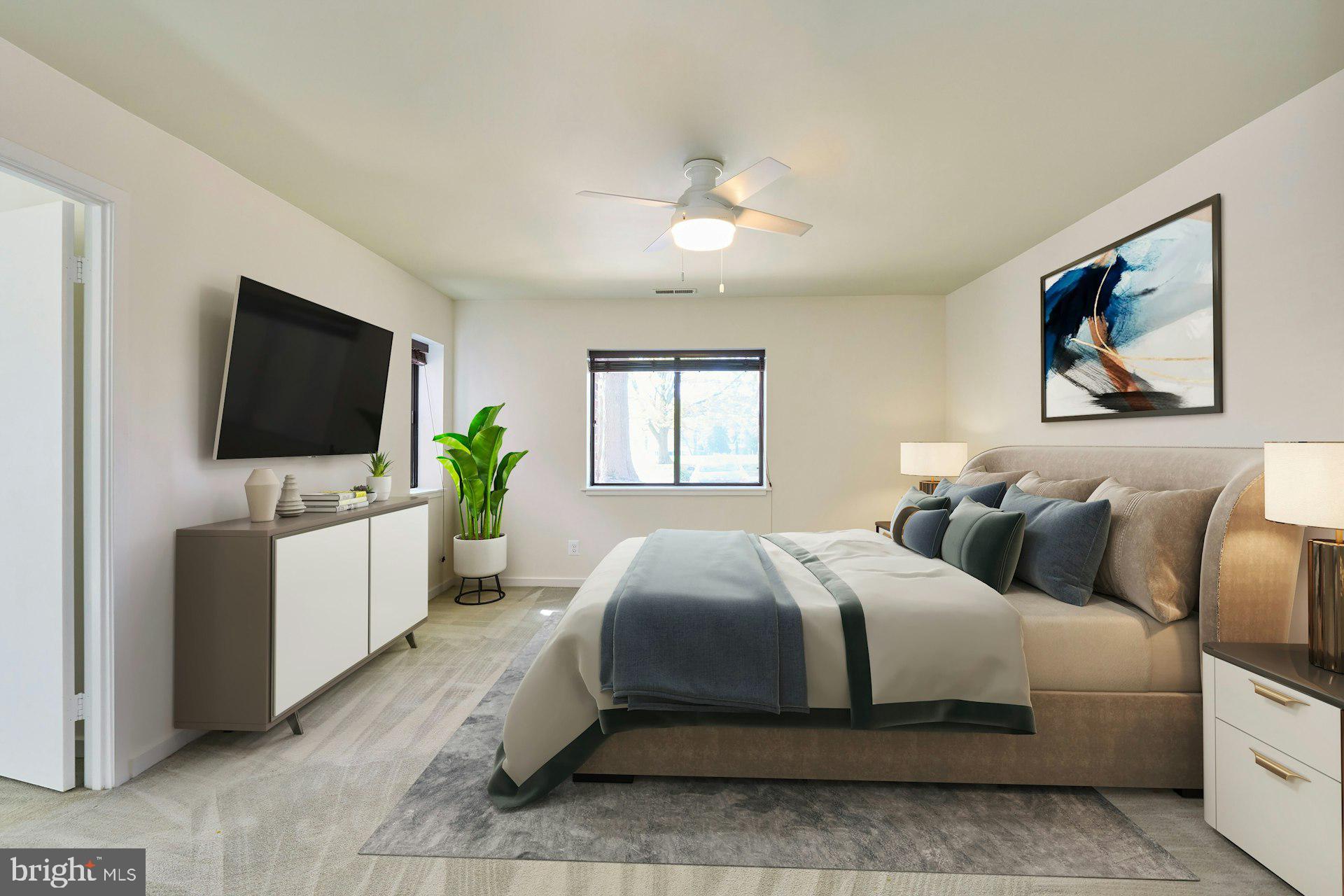 11500 Fairway Drive, Unit 101 Reston, VA 20190 - Photo 24 of 40 a bedroom with a bed and a flat screen tv