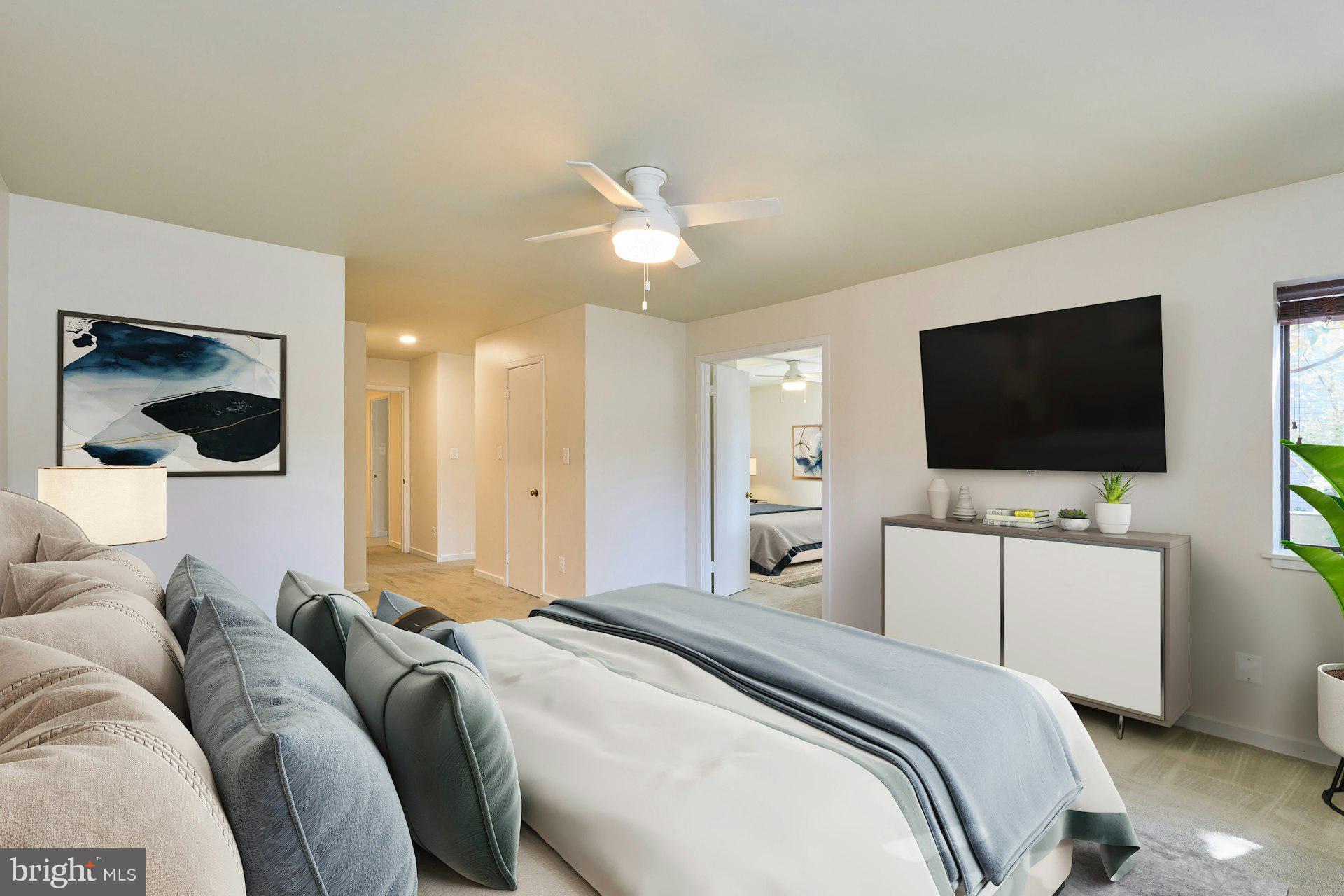11500 Fairway Drive, Unit 101 Reston, VA 20190 - Photo 25 of 40 a bedroom with a bed and a flat screen tv