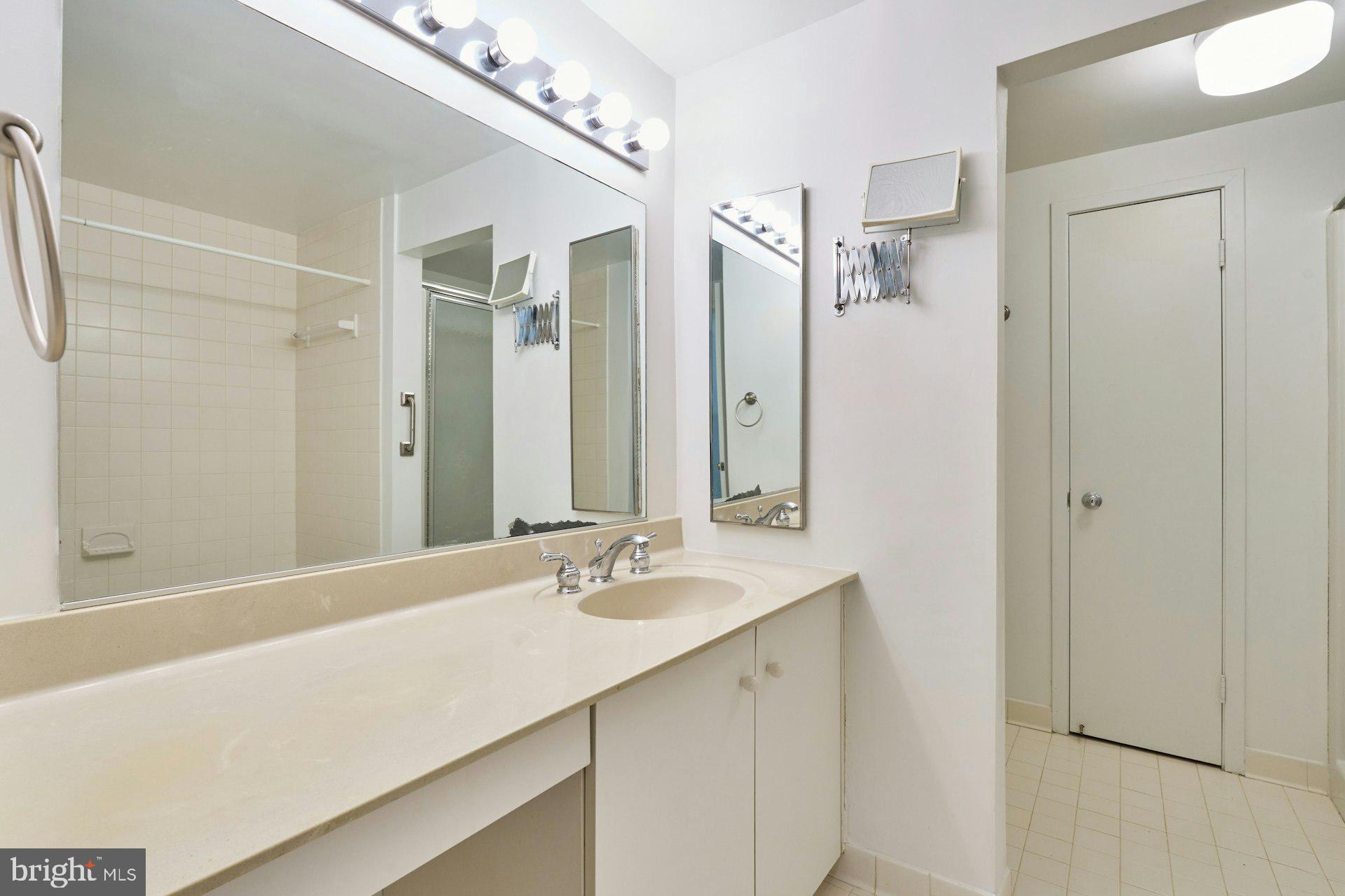 11500 Fairway Drive, Unit 101 Reston, VA 20190 - Photo 28 of 40 a bathroom with a sink double vanity and a mirror