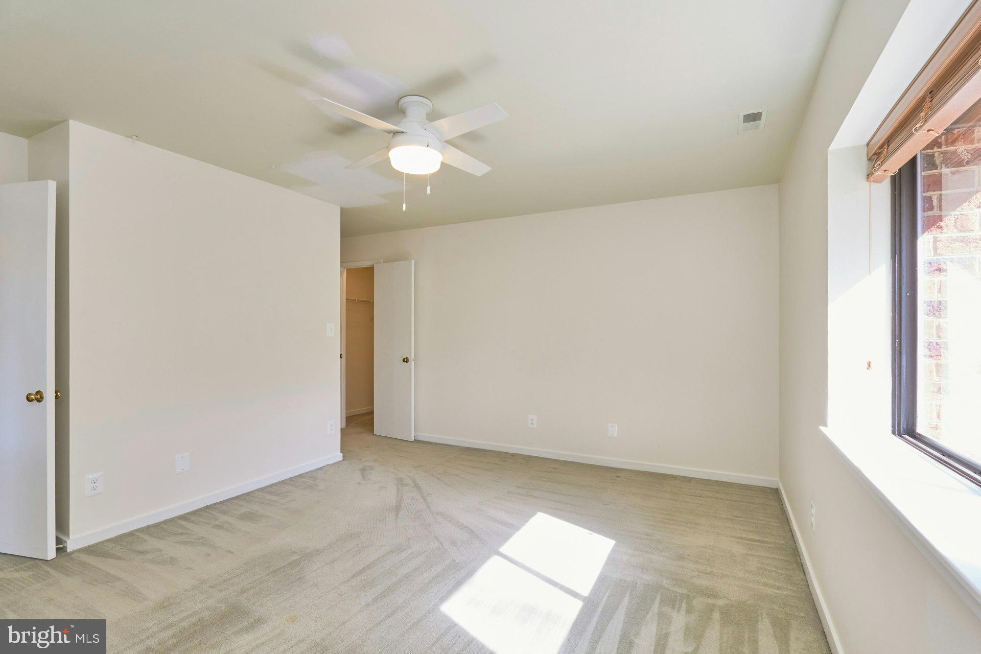 11500 Fairway Drive, Unit 101 Reston, VA 20190 - Photo 35 of 40 an empty room with windows and fan