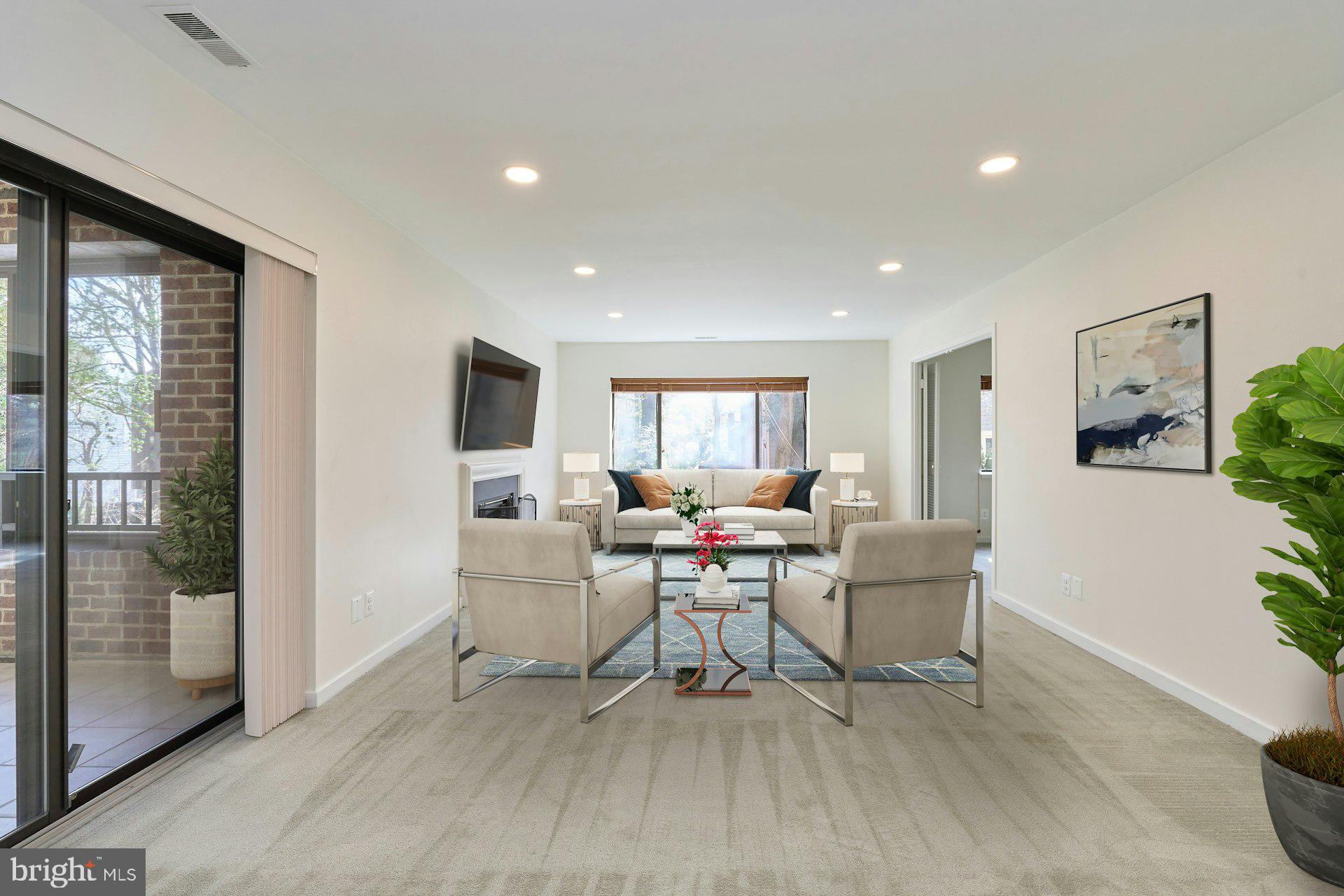 11500 Fairway Drive, Unit 101 Reston, VA 20190 - Photo 8 of 40 a living room with furniture a window and a table