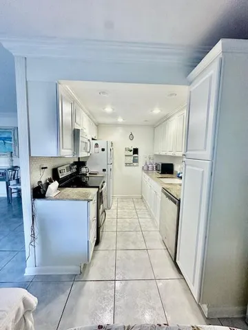 a kitchen with a refrigerator and a sink