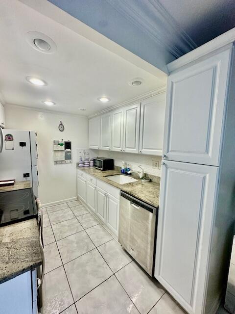 1080 Exeter Boca Raton, FL 33434 - Photo 4 of 37 a kitchen with white cabinets and white appliances