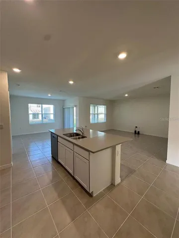 a bathroom with a sink a toilet a mirror and bathtub
