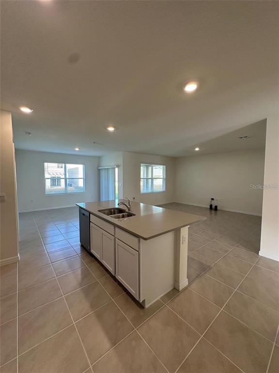 3767 Paragon Lane Clermont, FL 34714 - Photo 12 of 19 a kitchen with stainless steel appliances a sink stove and cabinets