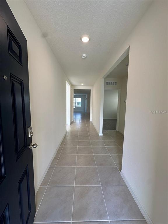 3767 Paragon Lane Clermont, FL 34714 - Photo 13 of 19 a view of hallway with bathroom and a mirror