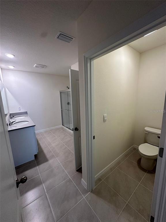 3767 Paragon Lane Clermont, FL 34714 - Photo 6 of 19 a bathroom with a toilet and a shower