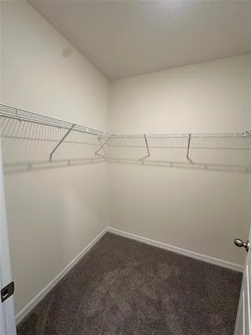 a large white kitchen with a large window and white cabinets