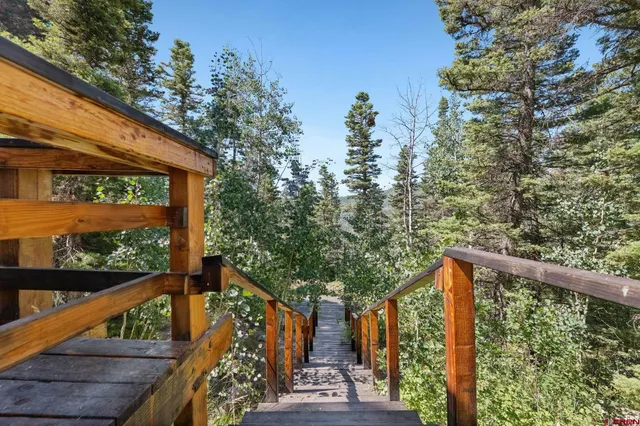 a view of balcony with wooden floor and fence