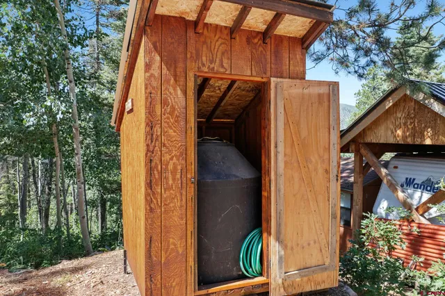 a backyard of a house with a yard and outdoor seating