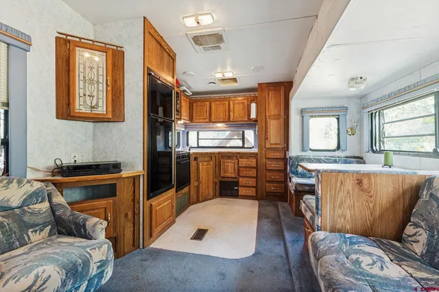a kitchen with stainless steel appliances granite countertop a refrigerator and cabinets