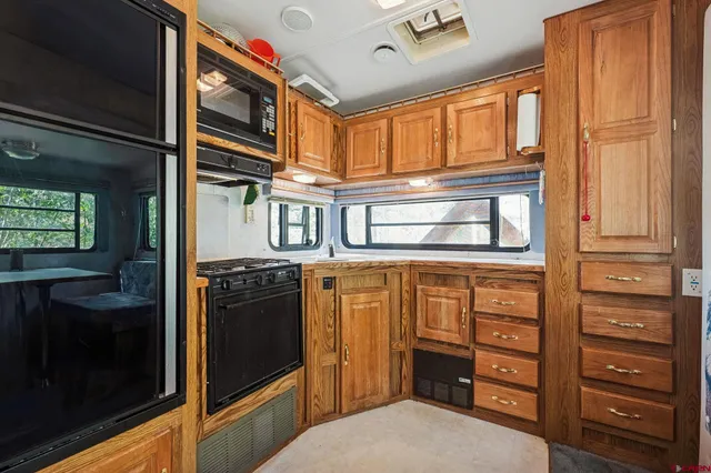 a kitchen with a stove a sink and a refrigerator