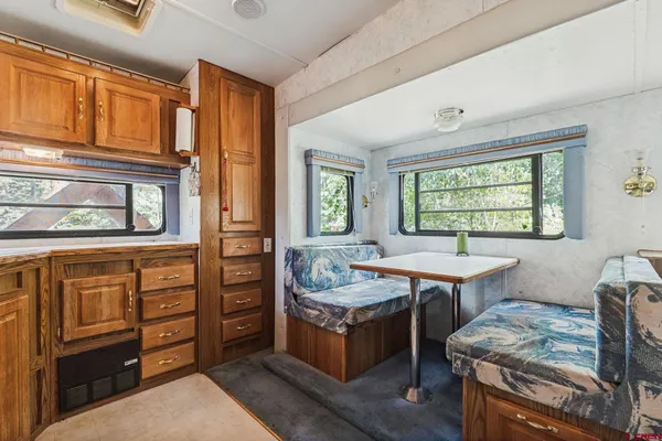 a bedroom with a bed window and a table in it