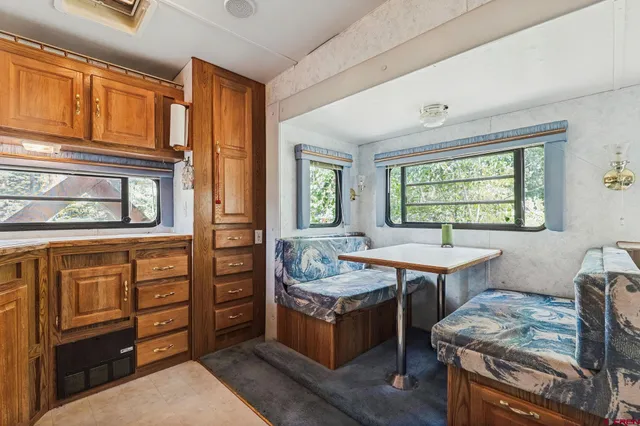 a bedroom with a bed window and a table in it