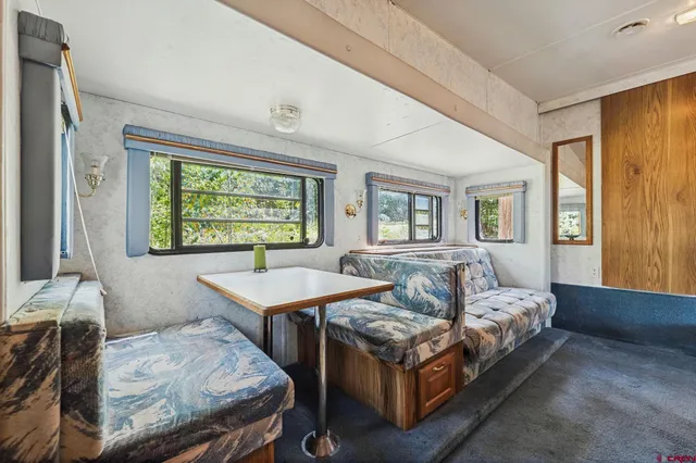a view of a hallway with wooden shelves