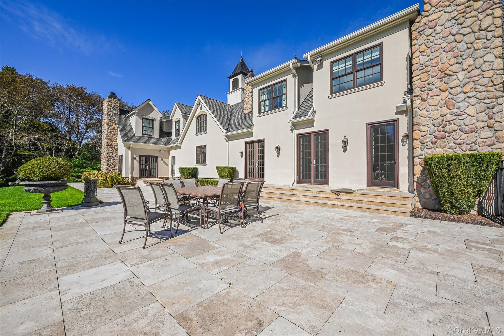 15 High Ridge Lane Oyster Bay, NY 11771 - Photo 19 of 25 a view of a patio with a table and chairs and potted plants