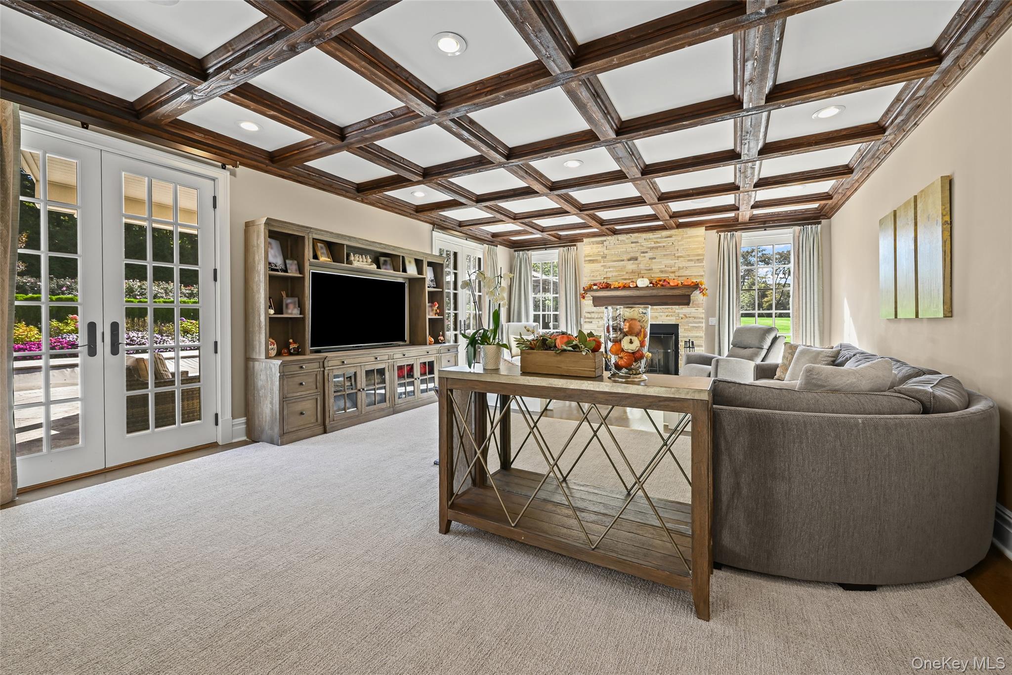 15 High Ridge Lane Oyster Bay, NY 11771 - Photo 7 of 25 a living room with furniture a flat screen tv and a chandelier