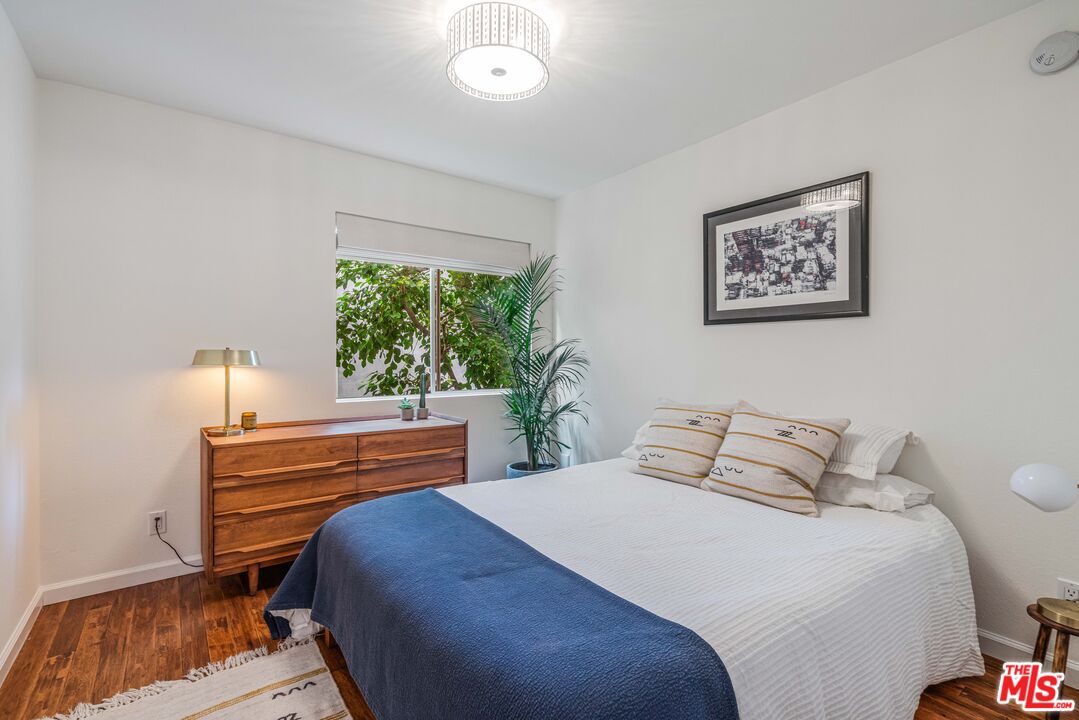 24 Westwind Street, Unit C Marina del Rey, CA 90292 - Photo 25 of 35 a bedroom with a bed and a painting on the wall