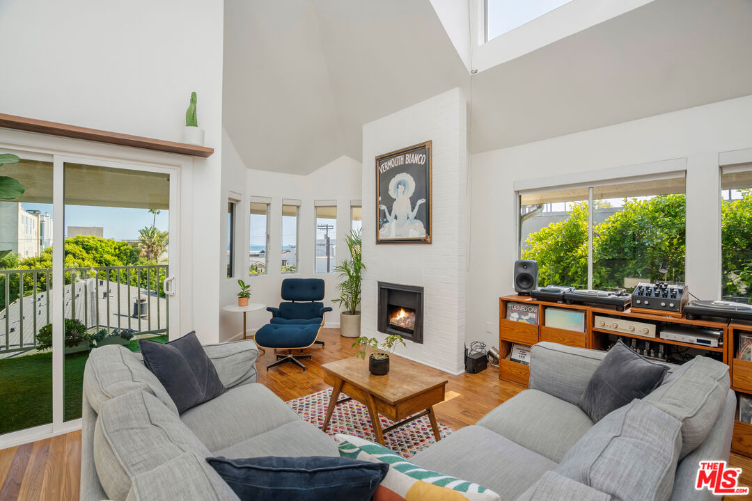 24 Westwind Street, Unit C Marina del Rey, CA 90292 - Photo 4 of 35 a living room with furniture and a fireplace