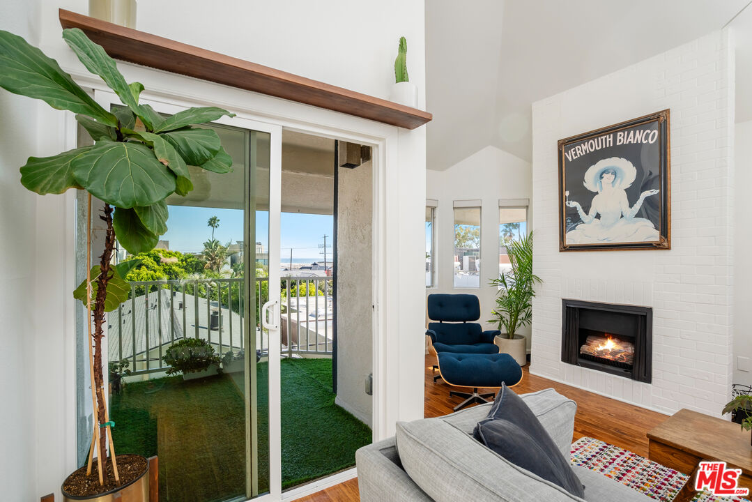 24 Westwind Street, Unit C Marina del Rey, CA 90292 - Photo 5 of 35 a living room with furniture and a fireplace
