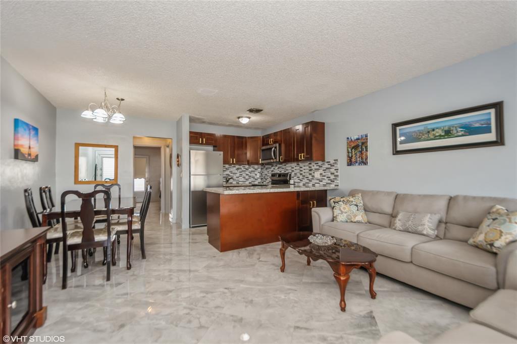 800 Southwest 11th Avenue, Unit 17 Hallandale Beach, FL 33009 - Photo 11 of 18 a living room with furniture and view of kitchen