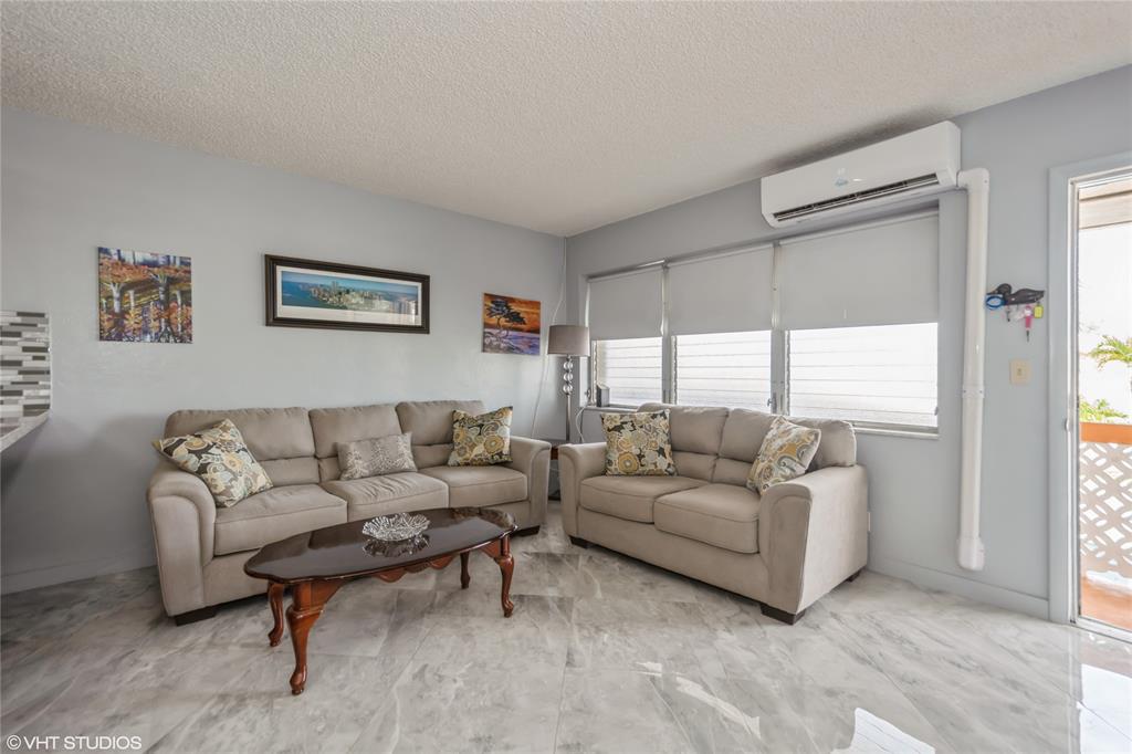 800 Southwest 11th Avenue, Unit 17 Hallandale Beach, FL 33009 - Photo 13 of 18 a living room with furniture and a large window