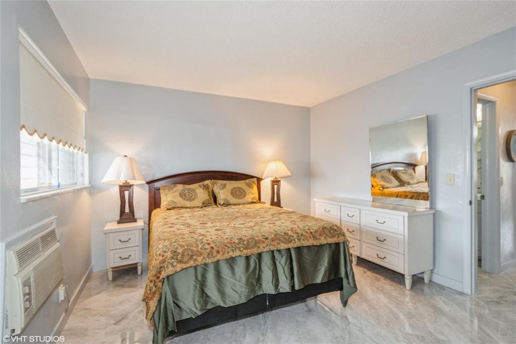 800 Southwest 11th Avenue, Unit 17 Hallandale Beach, FL 33009 - Photo 15 of 18 a bedroom with a bed and a cabinets