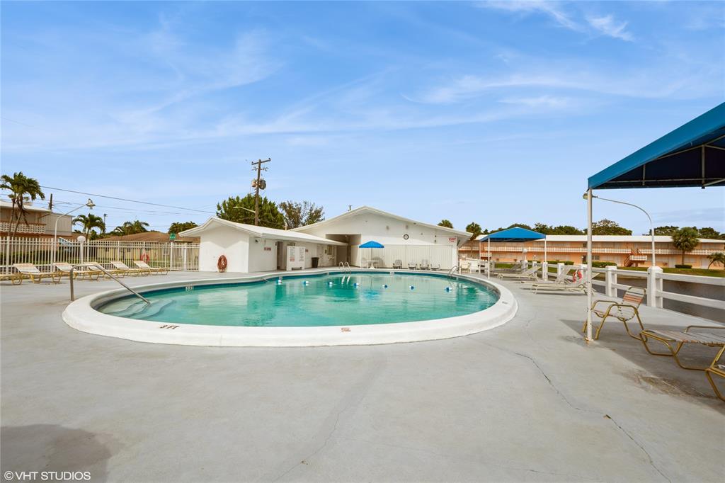 800 Southwest 11th Avenue, Unit 17 Hallandale Beach, FL 33009 - Photo 17 of 18 a roof deck with a table and chairs and potted plants