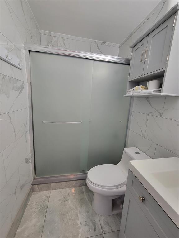 800 Southwest 11th Avenue, Unit 17 Hallandale Beach, FL 33009 - Photo 10 of 18 a white toilet sitting next to a bathroom sink