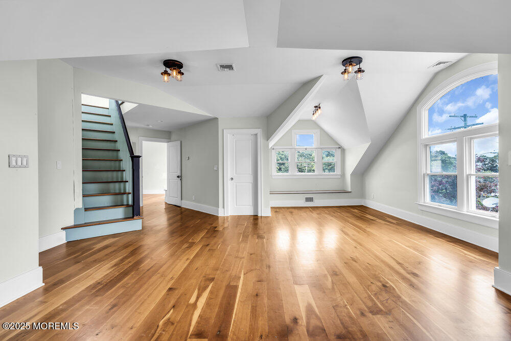 4 Oneida Avenue Atlantic Highlands, NJ 07716 - Photo 49 of 80 a view of an empty room with wooden floor and windows