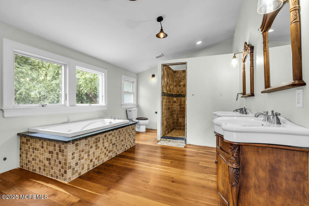 4 Oneida Avenue Atlantic Highlands, NJ 07716 - Photo 56 of 80 a bathroom with a sink a mirror and a bathtub