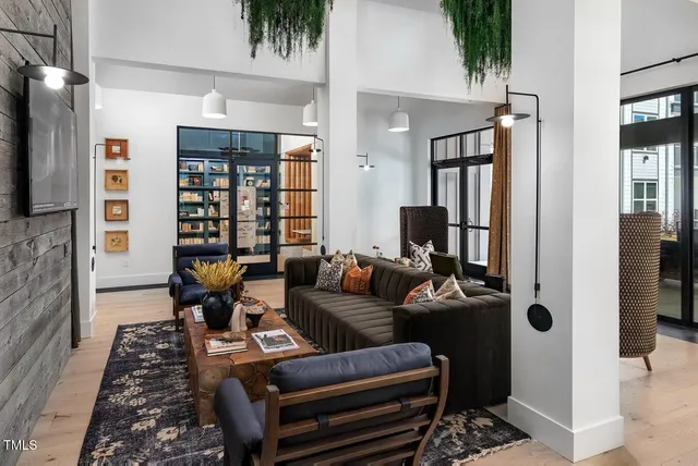 a living room with furniture a flat screen tv and a rug