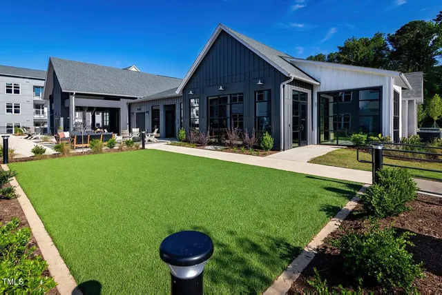 a front view of a house with swimming pool having outdoor seating