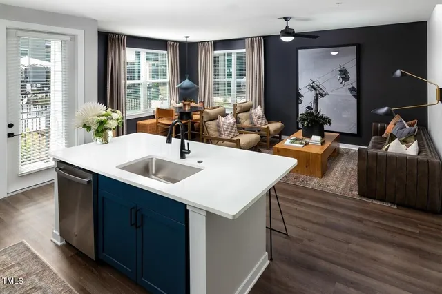 a kitchen with a sink cabinets and wooden floor