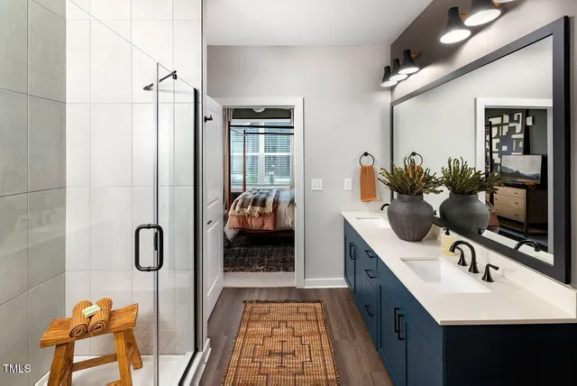 a bathroom with a sink a mirror and shower